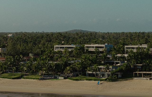 Pessoa caminhando no mar com equipamento de kitesurf